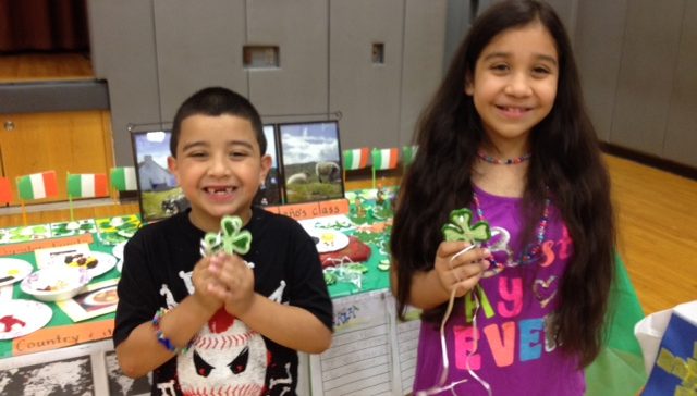 Multicultural Night at John Barry Elementary School: Students posing with four leaf clovers from the Ireland table